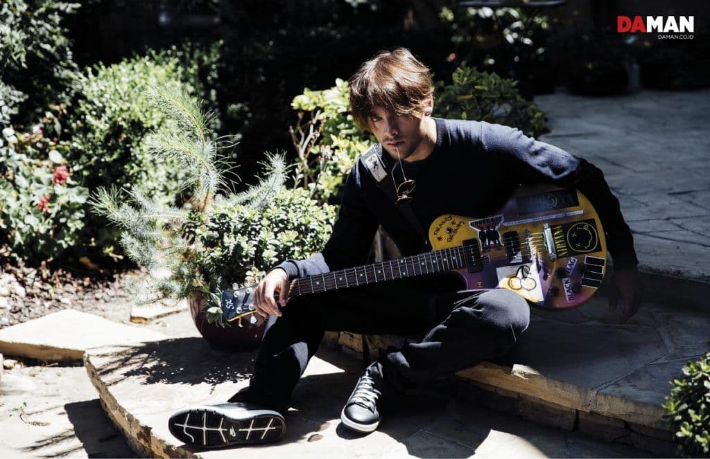 Dylan Sprayberry of Teen Wolf in Sweater by Ben Sherman, trousers by DuSty, sunglasses by ray-Ban, shoes by Nike