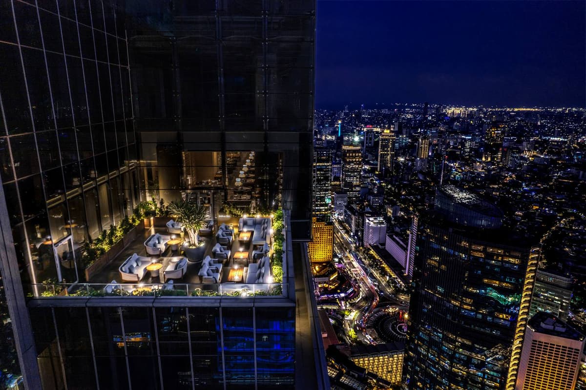 Eden Bar Jakarta terrace at Pan Pacific Jakarta overlooking the illuminated city skyline.