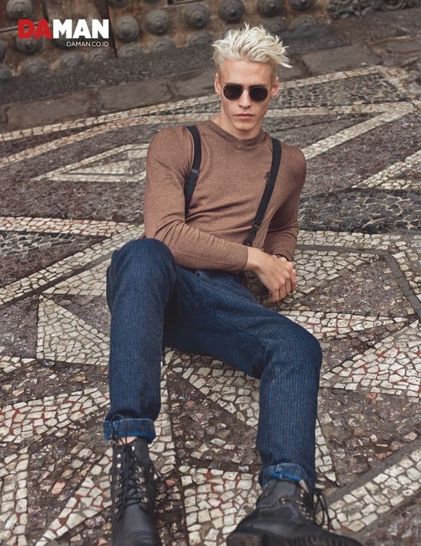 Model Oliver Stummvoll by GREG SWALES in Sweater by Ralph Lauren, denim trousers by Diesel, sunglasses by Ray-Ban by Luxotica, shoes by Giorgio Armani