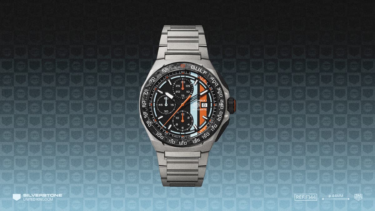 The black opalin dial with blue and orange vertical stripes, and the blue lacquered track running around the dial